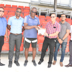 Mr Woodcock handing over the cheque to Mr Boniface in the presence of Ceps’ chief executive Alvin Laurence and members of the Legend Foundation