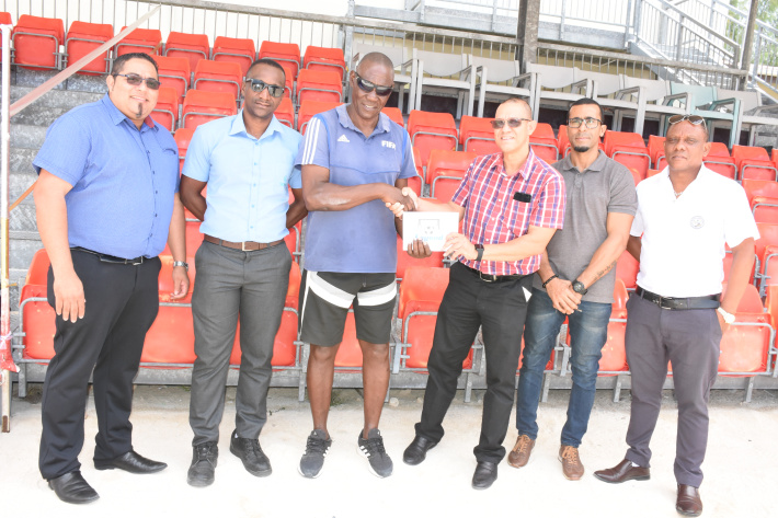 Mr Woodcock handing over the cheque to Mr Boniface in the presence of Ceps’ chief executive Alvin Laurence and members of the Legend Foundation